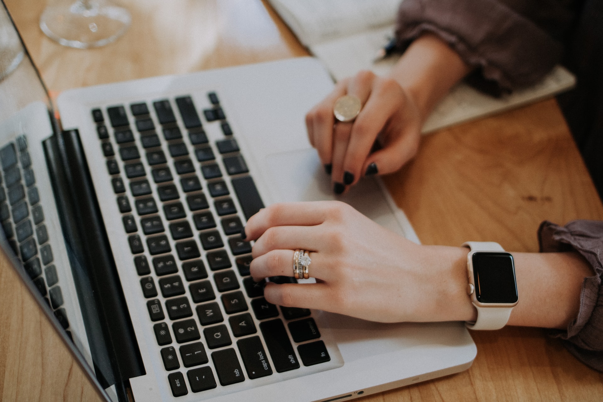 Close up of woman typing on a laptop